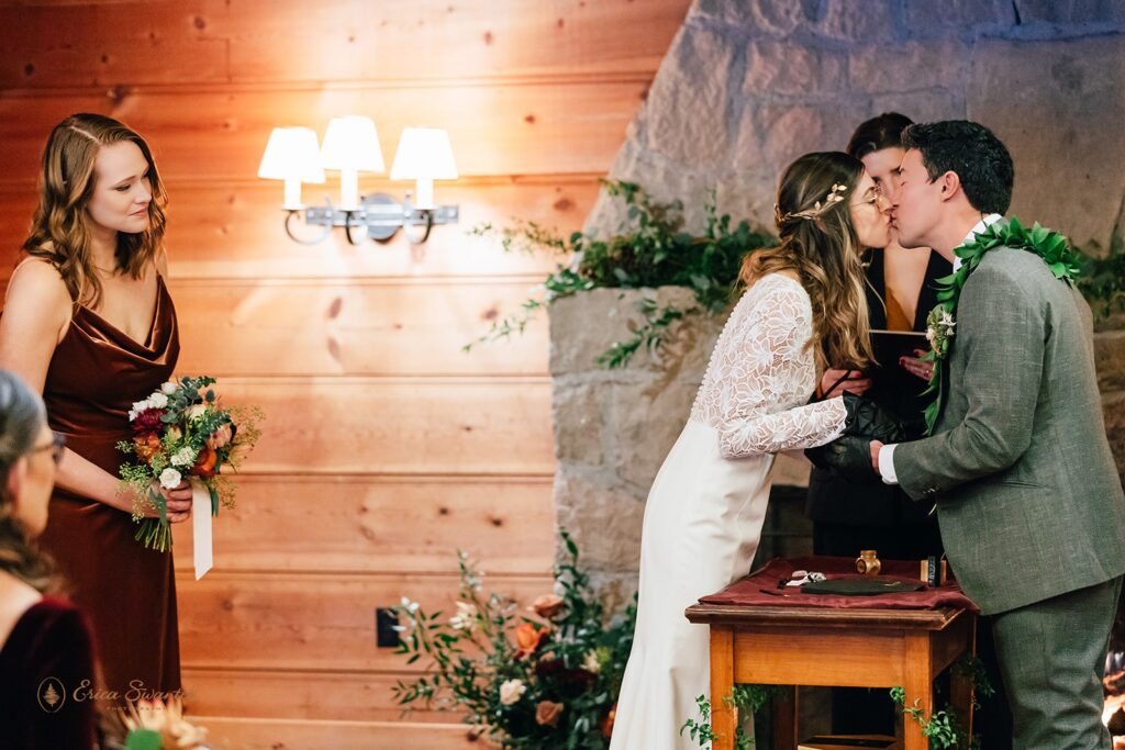 bride and groom performing a kitsungi unity ceremony during their cabin wedding day