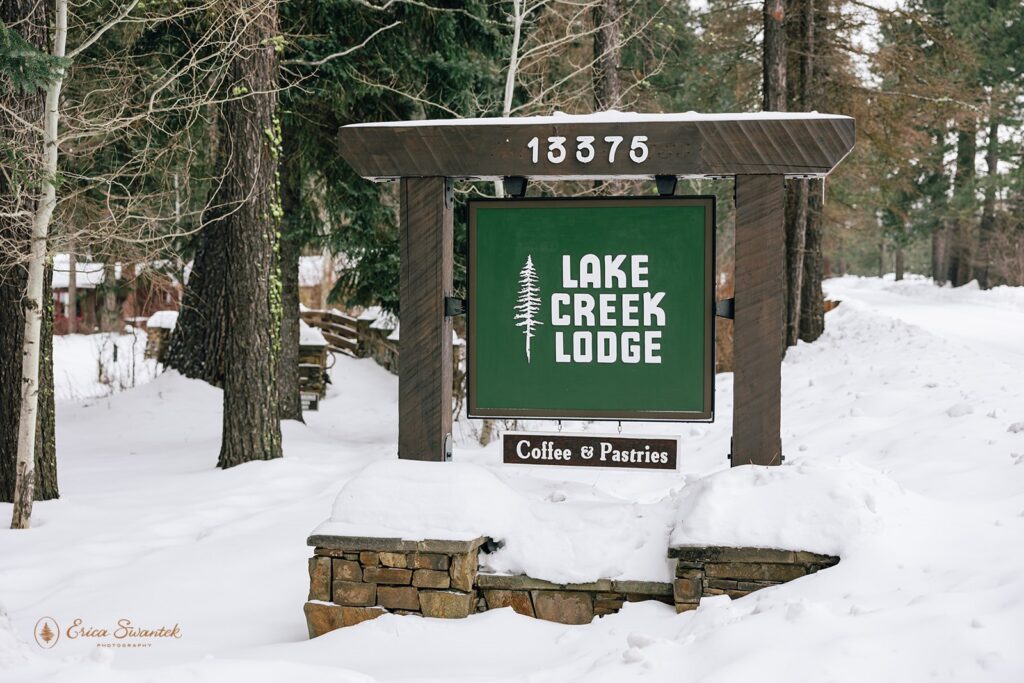 Lake Creek Lodge sign surrounded by snowy landscapes