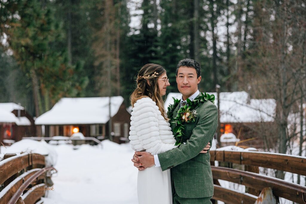 bride and groom surrounded by winter snow and landscapes during their intimate cabin wedding at Lake Creek Lodge