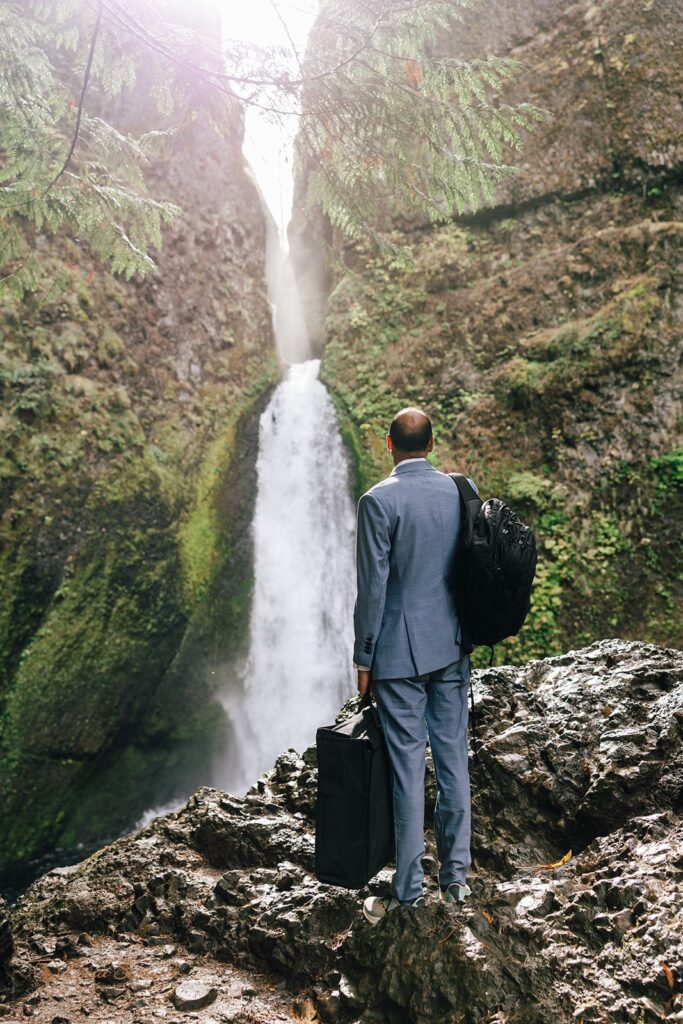 groom portrait on the wahclella falls trail with waterfalls in the backdrop