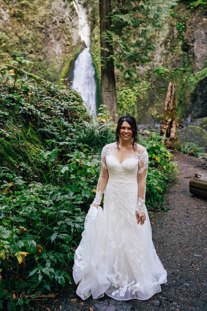 bridal portrait on the wahclella falls trail with waterfalls in the backdrop