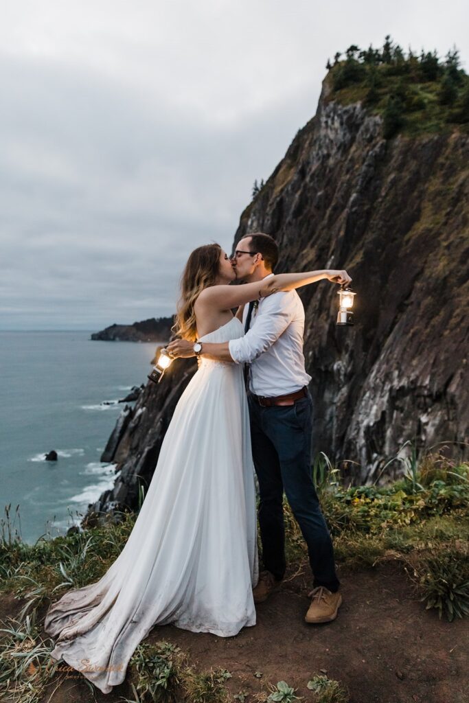 bride and groom hugging while holding lanterns during their nighttime elopement session