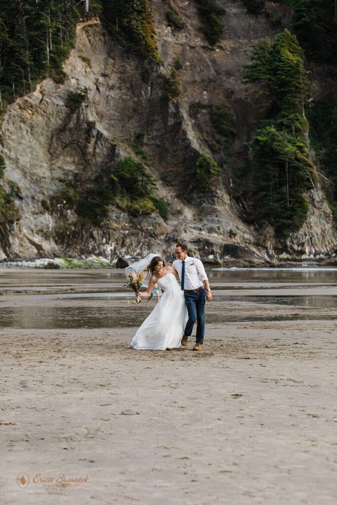 playful elopement couple during their all day beach elopement in Oregon