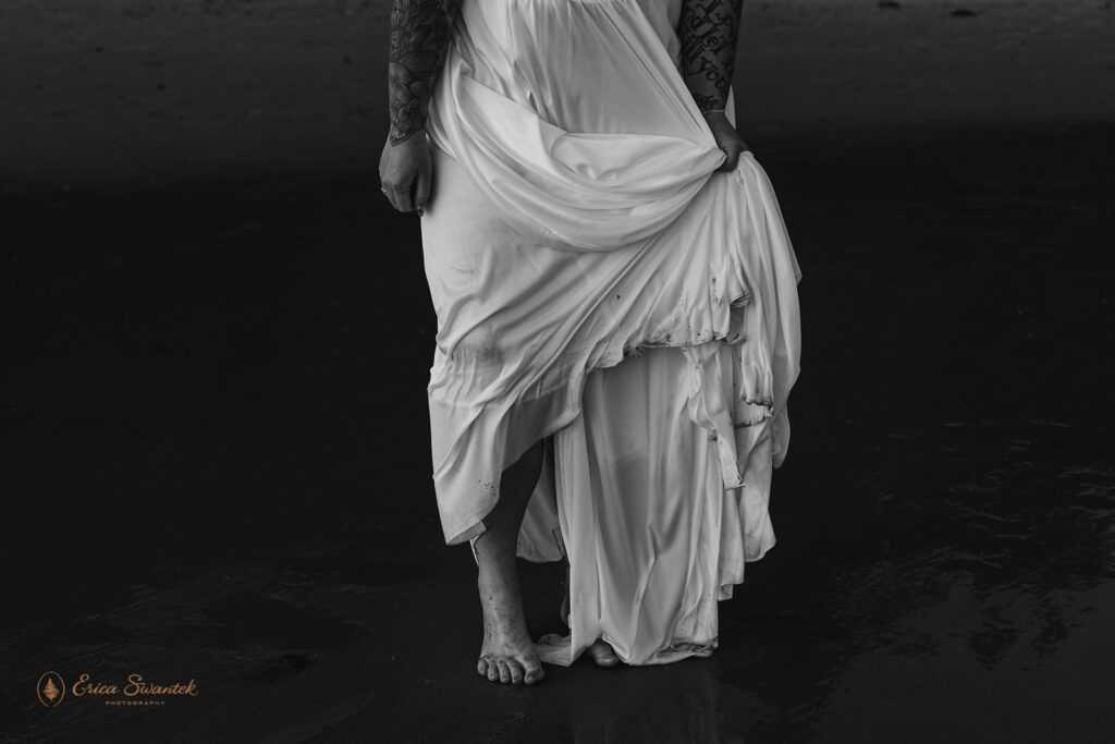 artistic close up of bride holding her dress