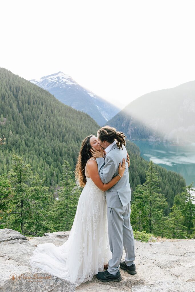 romantic elopement couple kissing during their all day elopement in PNW