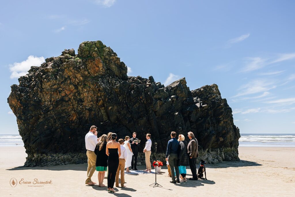 elopement ceremony with closest loved ones by a rock at the Oregon coast