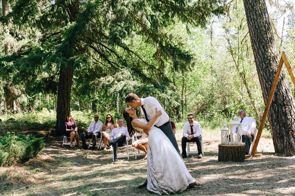 bride and groom sharing a first dance in the forest