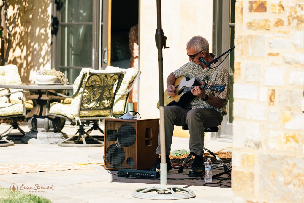 bride's dad playing guitar for the guests