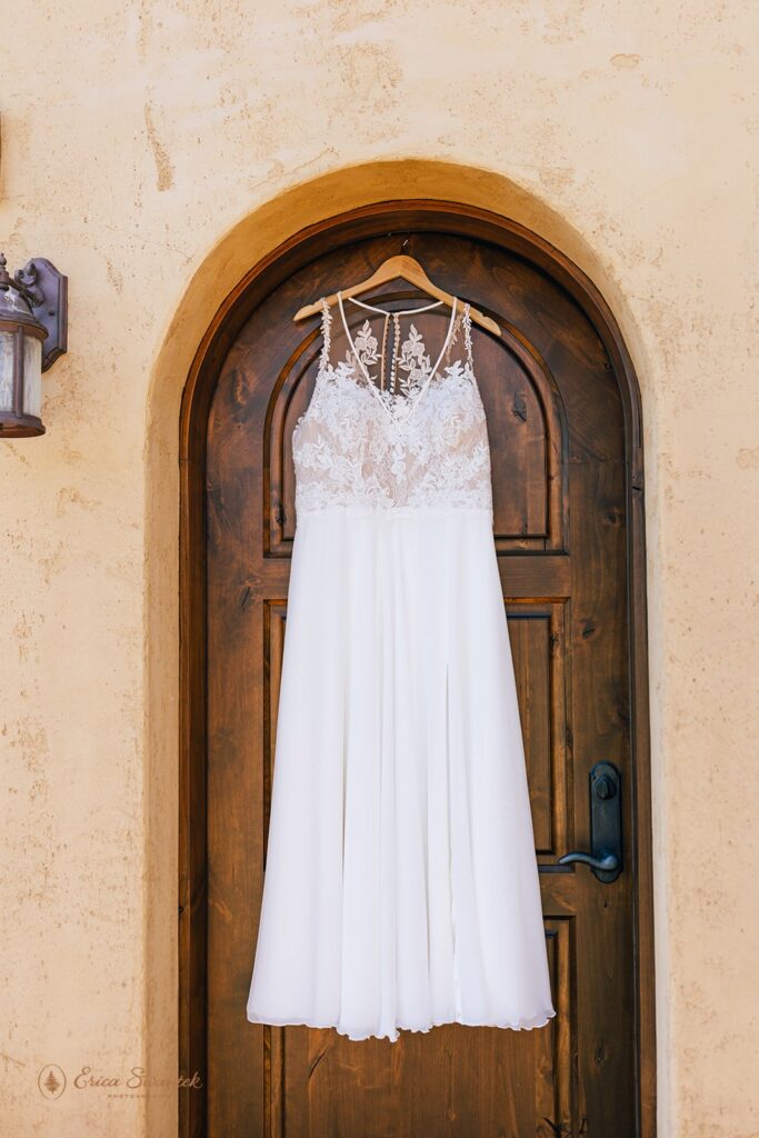 close up of dress hanging by a wooden door