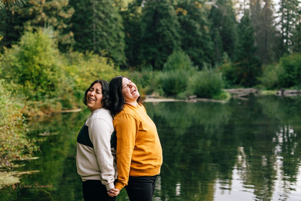 lgbtq couple having a blast during their pre wedding session at suttle lake lodge