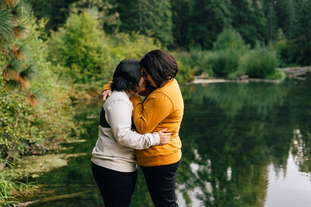 lgbtq couple having a blast during their pre wedding session at suttle lake lodge