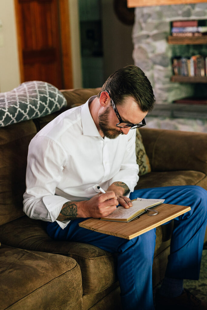 A groom writes out his wedding vows in his cabin.