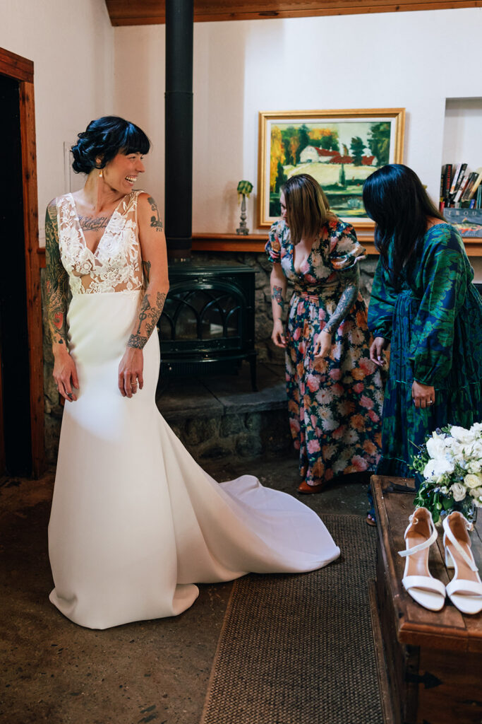A bride puts on her wedding dress in her cabin 