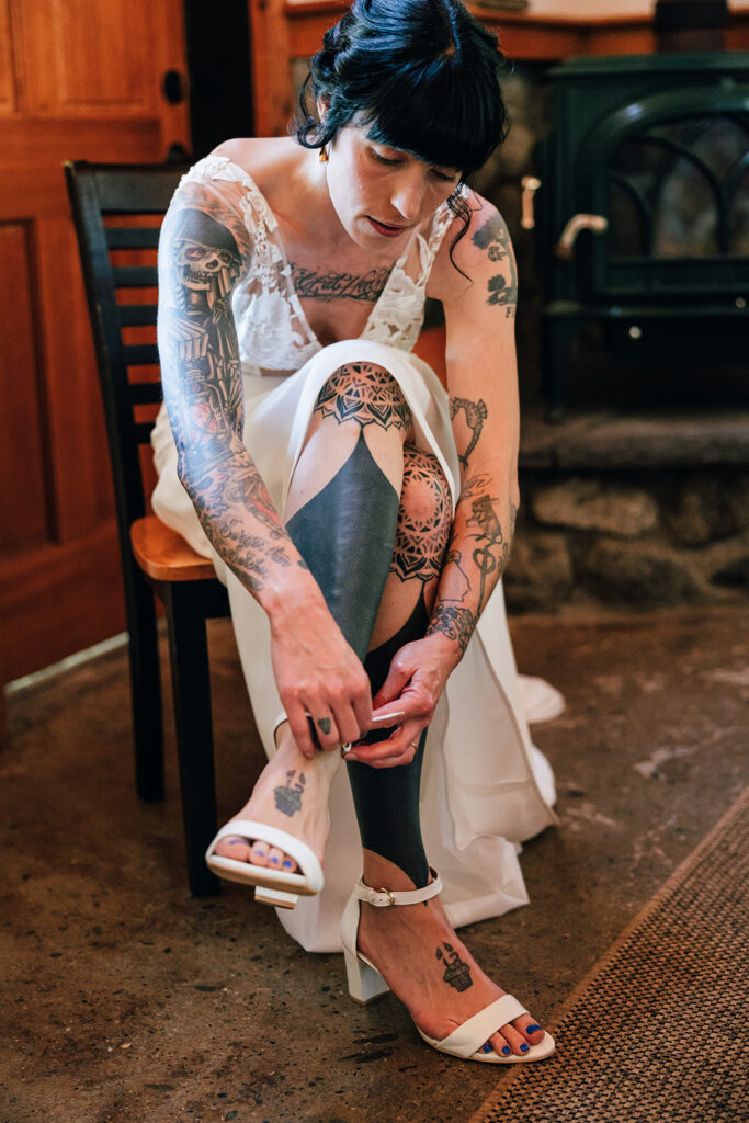 A bride puts on her shoes in her cabin.
