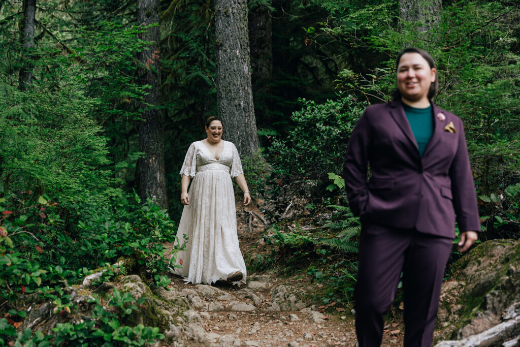 A bride in her purple suits awaits the first look with her bride in a beautiful boho gown