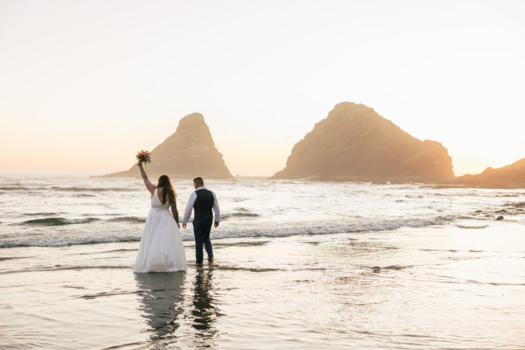 Sunset above Heceta Lighthouse on the Oregon Coast with a couple eloping.