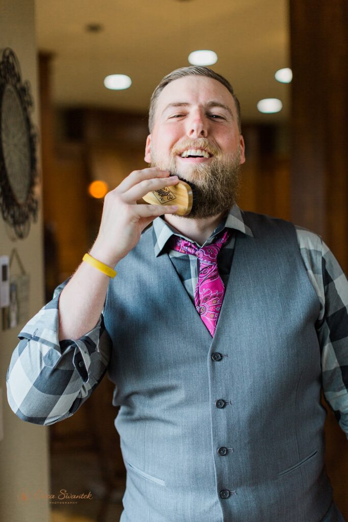 groom brushes his beard