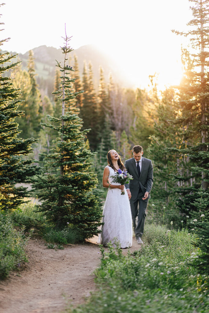 Couple standing in front of a glowing Mt. Rainier at their sunrise elopement.
