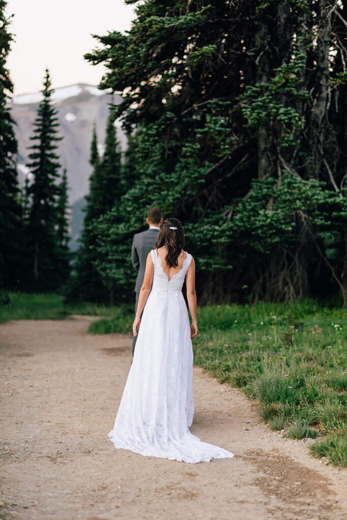 Bride and groom share a first look at their hiking elopement in Mt. Rainier National Park in Washington.