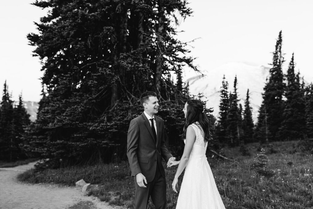 Bride and groom share a first look at their hiking elopement in Mt. Rainier National Park in Washington.