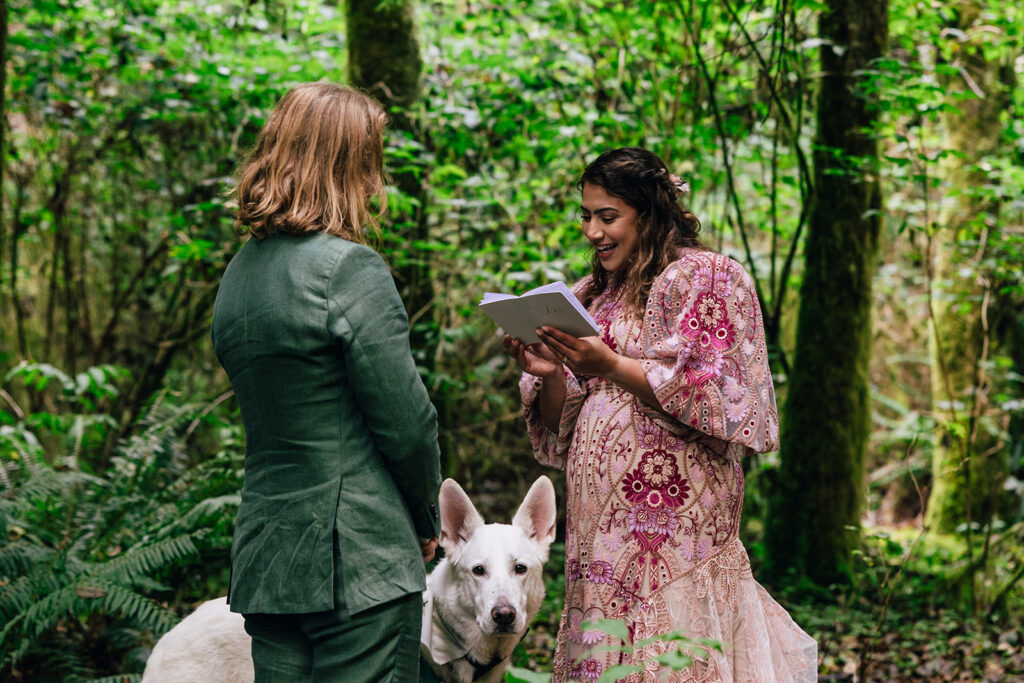 A couple reads private vows in the rainforest outside of Neskowin, Oregon.
