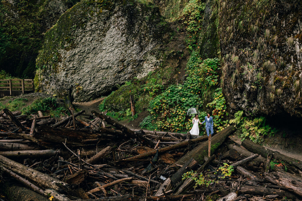 bride and groom hiking to a waterfall on their elopement day