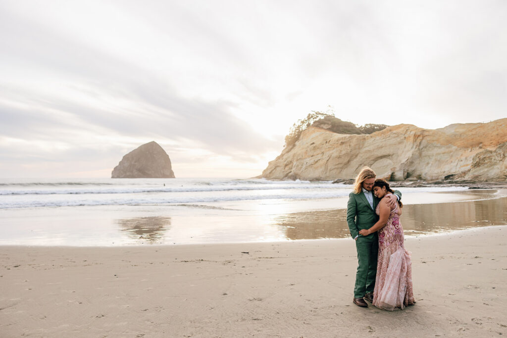 bride and groom in pink and green in Pacific City, Oregon. 