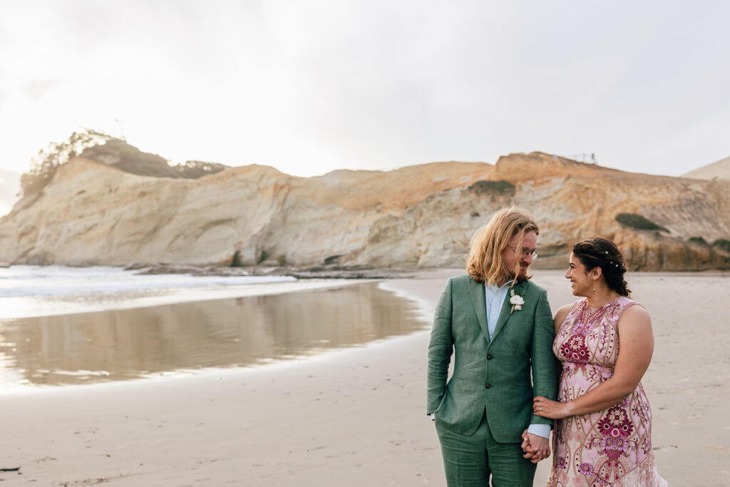 bride and groom in pink and green in Pacific City, Oregon. 
