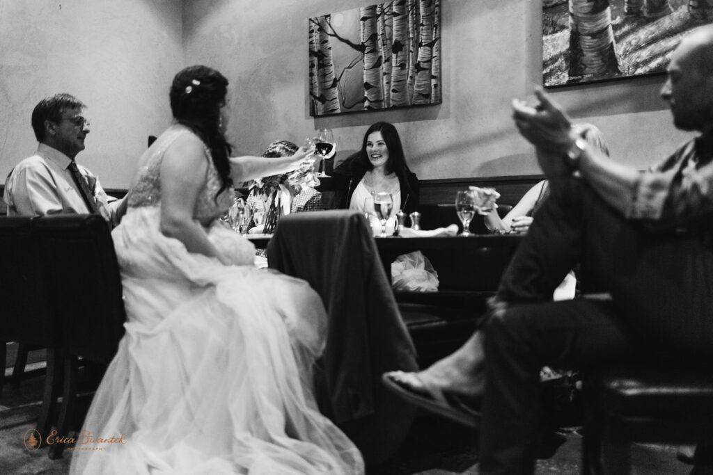 A bride toasts her sister after her speech on her elopement day.