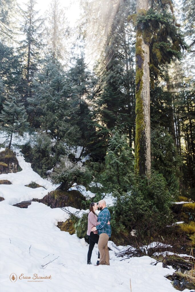 winter engagement photo in the forest