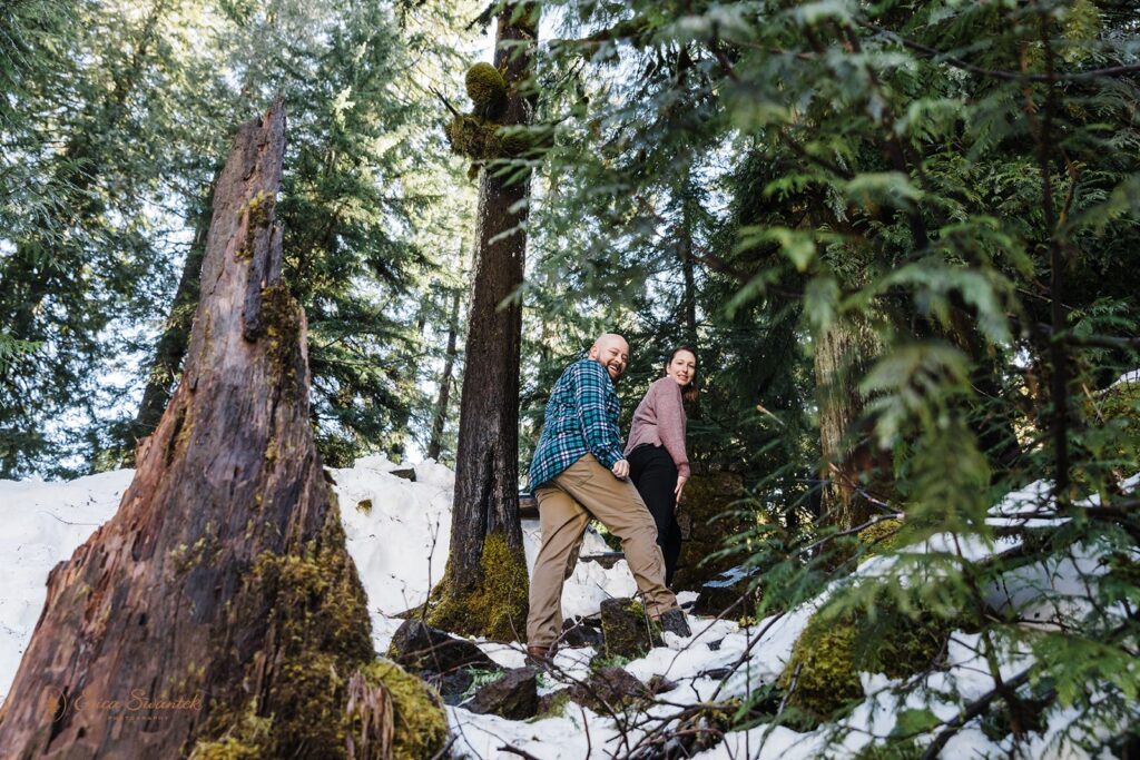 playful engaged couple going on a wintery hike together in PNW