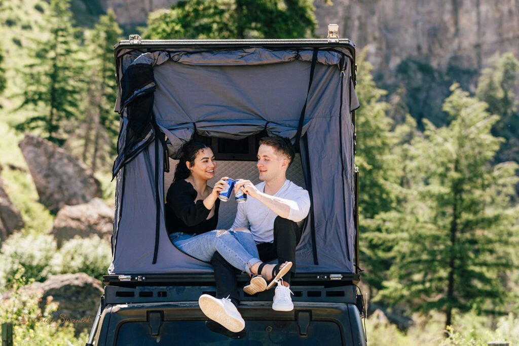 couple enjoying themselves on a car rooftop tent