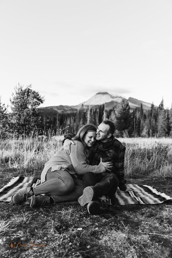 romantic field engagement photos with mountain and forest views in the backdrop in PNW