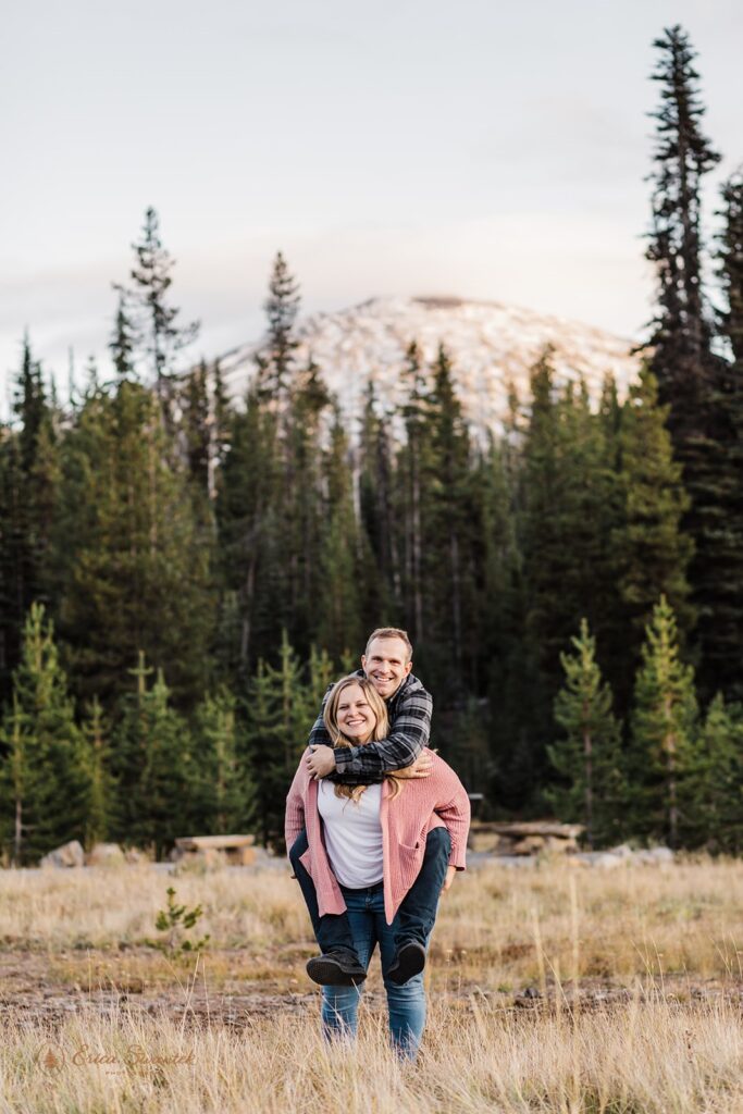 fun couple piggy back ride photos in a golden field