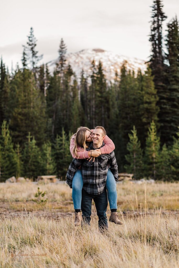 fun couple piggy back ride photos in a golden field