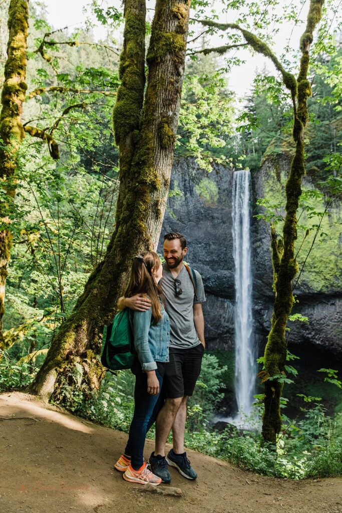 adventure engagement photos with a waterfall backdrop in PNW