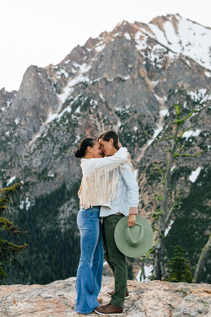 mountain adventure engagement photos with fun western outfits for the couple