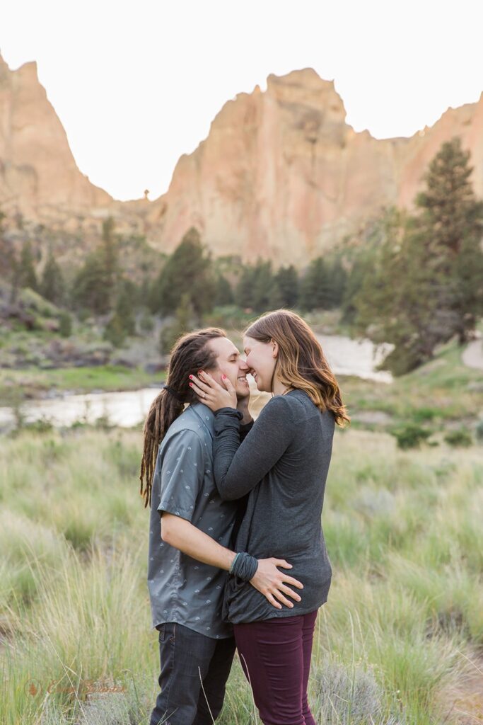 sweet engaged couple kissing during their PNW adventure engagement photos