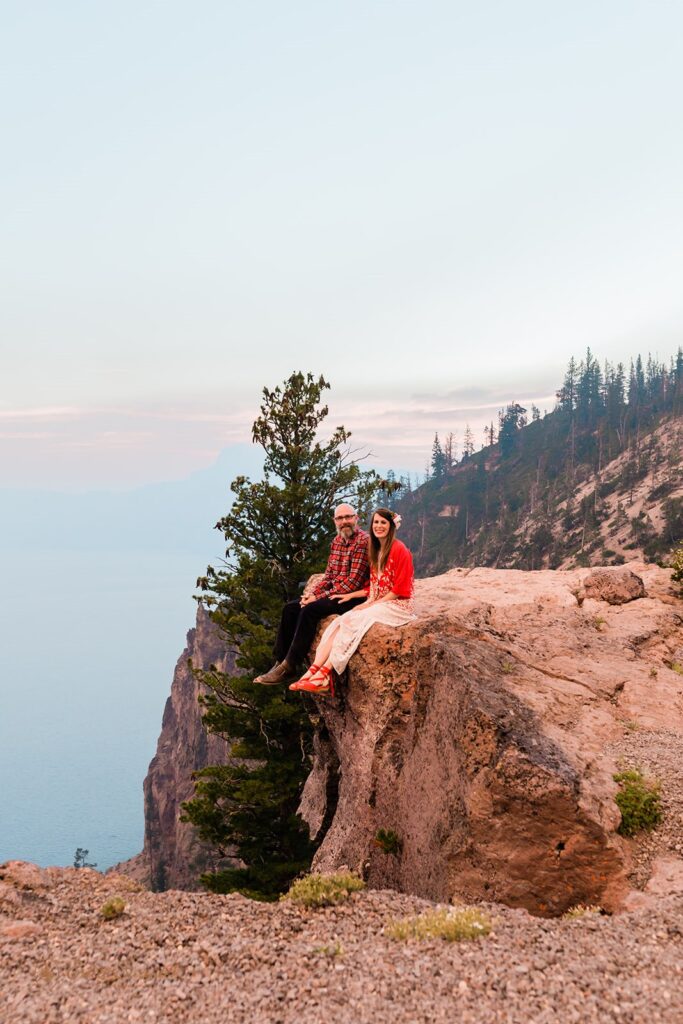 Newlyweds enjoy the magnificent sunset after their Crater Lake elopement in Oregon. | Erica Swantek Photography