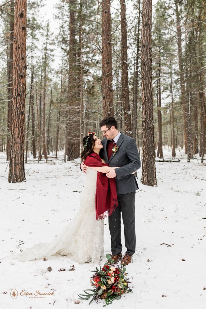 newly weds in a snowy forest for their PNW winter elopement