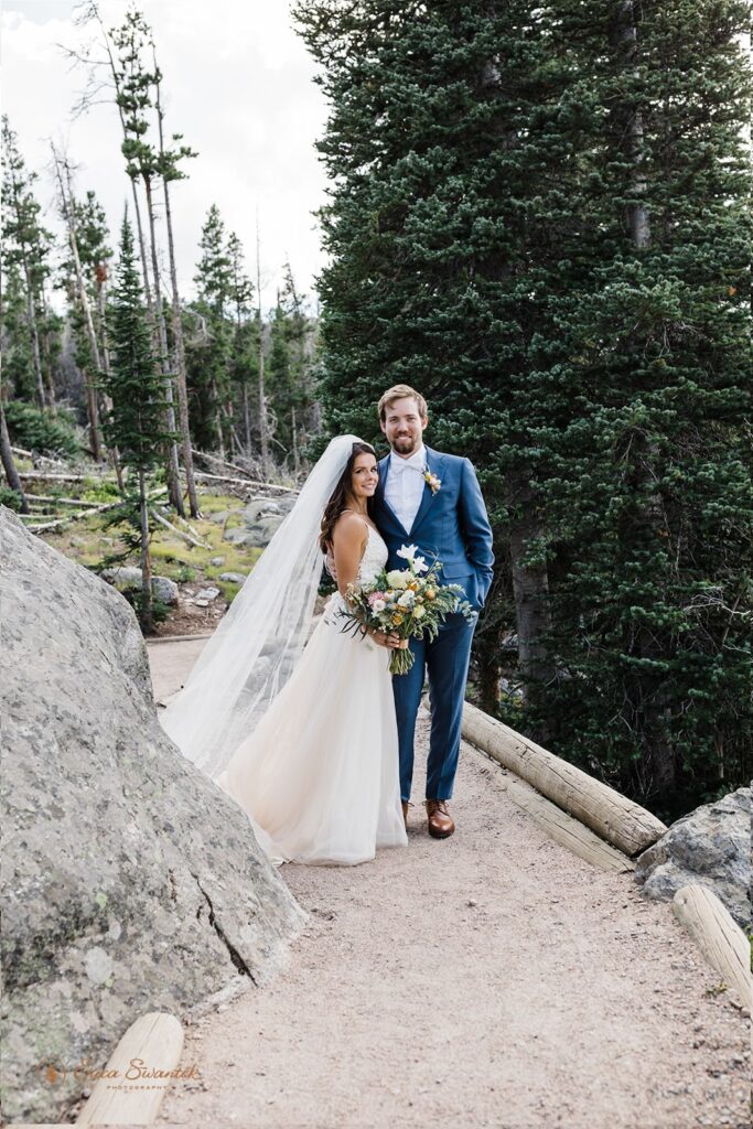 candid and playful elopement couple with wind messing with their attire and hair