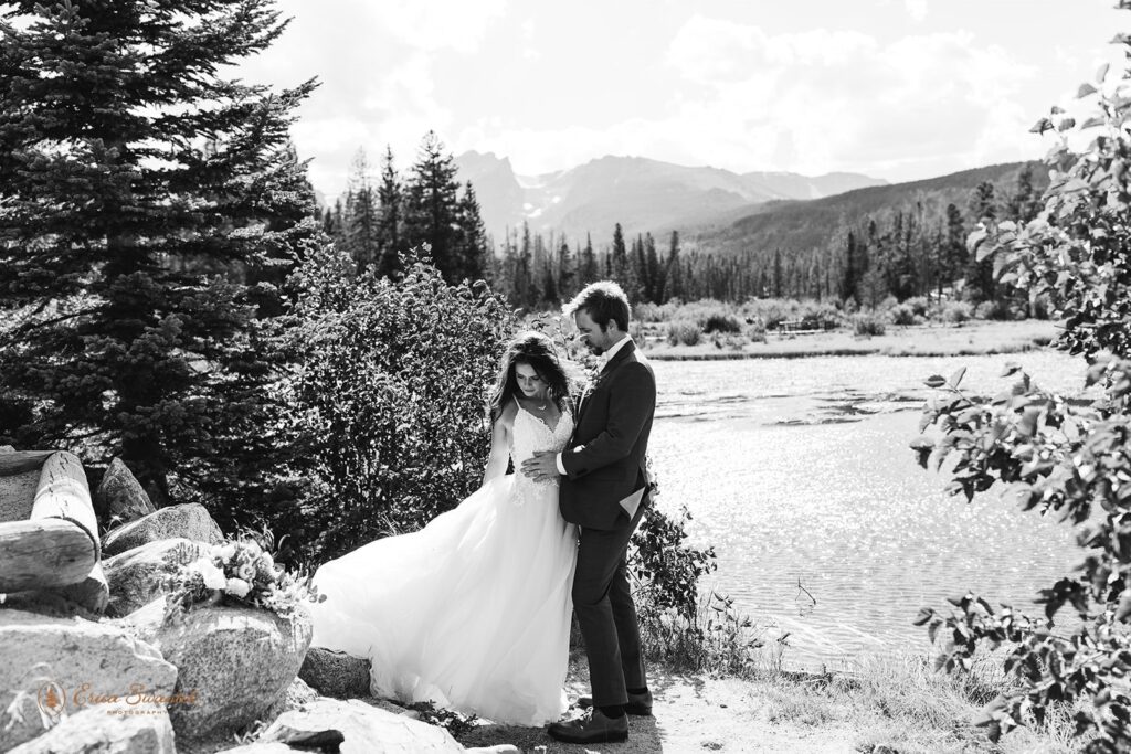 candid and playful elopement couple with wind messing with their attire and hair