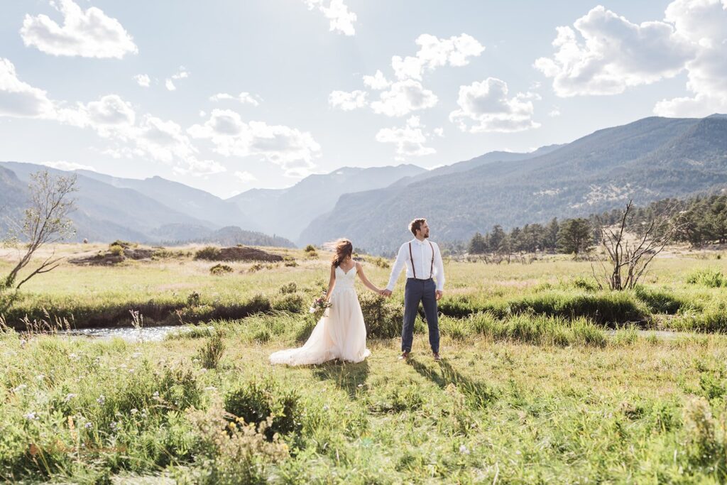 candid and playful elopement couple with wind messing with their attire and hair