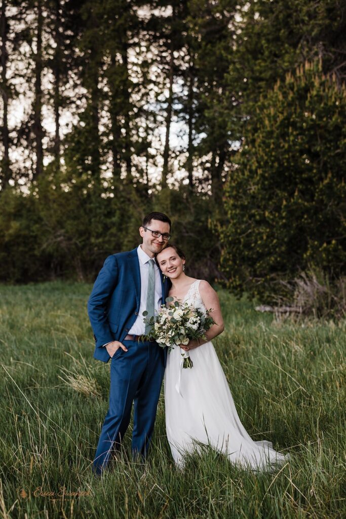 candid and playful elopement couple with wind messing with their attire and hair