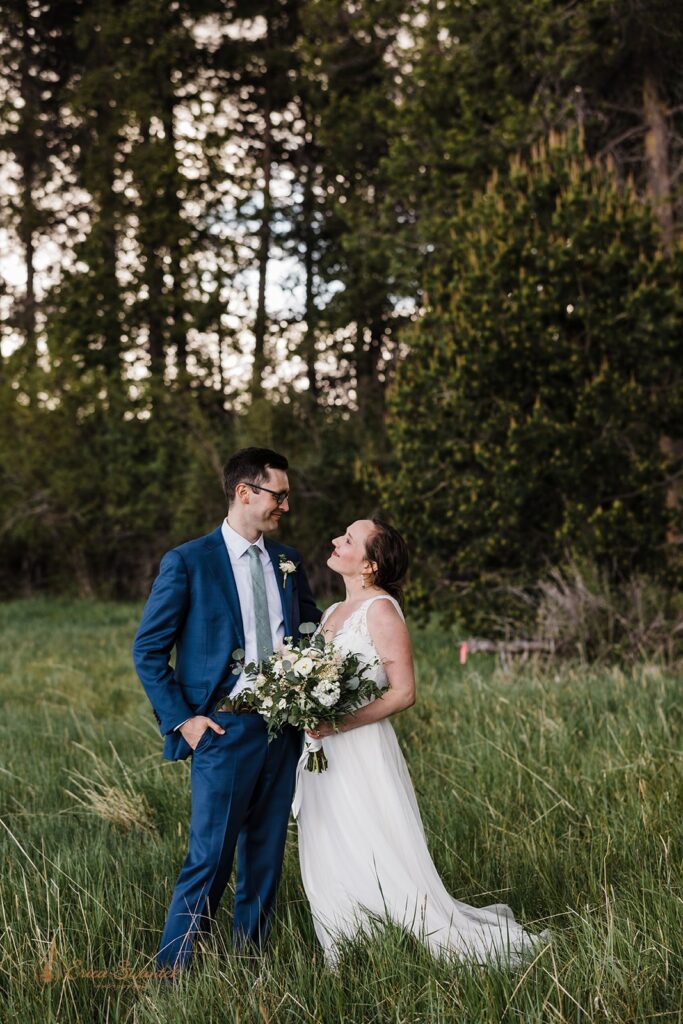 candid and playful elopement couple with wind messing with their attire and hair