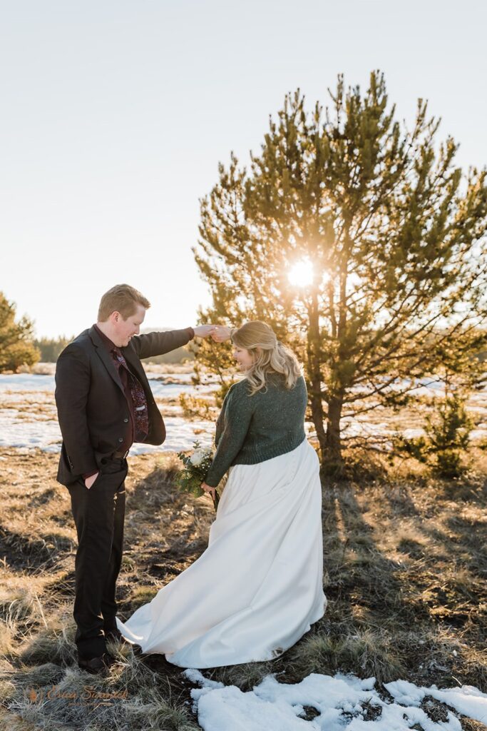 newly weds in a snowy field during their golden hour for their PNW elopement