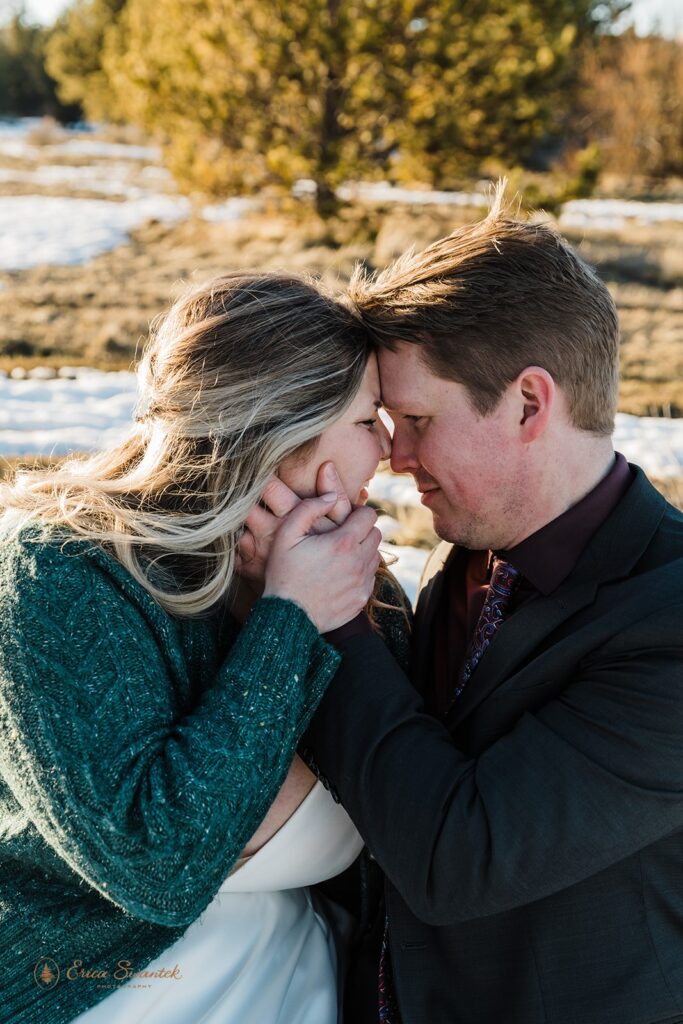 newly weds in a snowy field during their golden hour for their PNW elopement