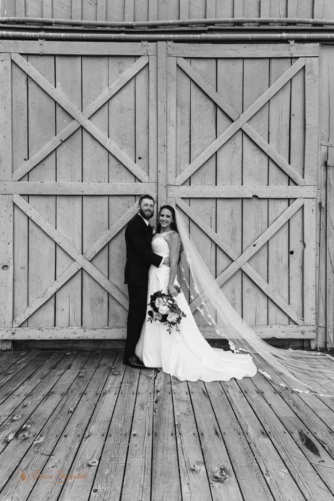 elopement couple posing by a rustic wooden door