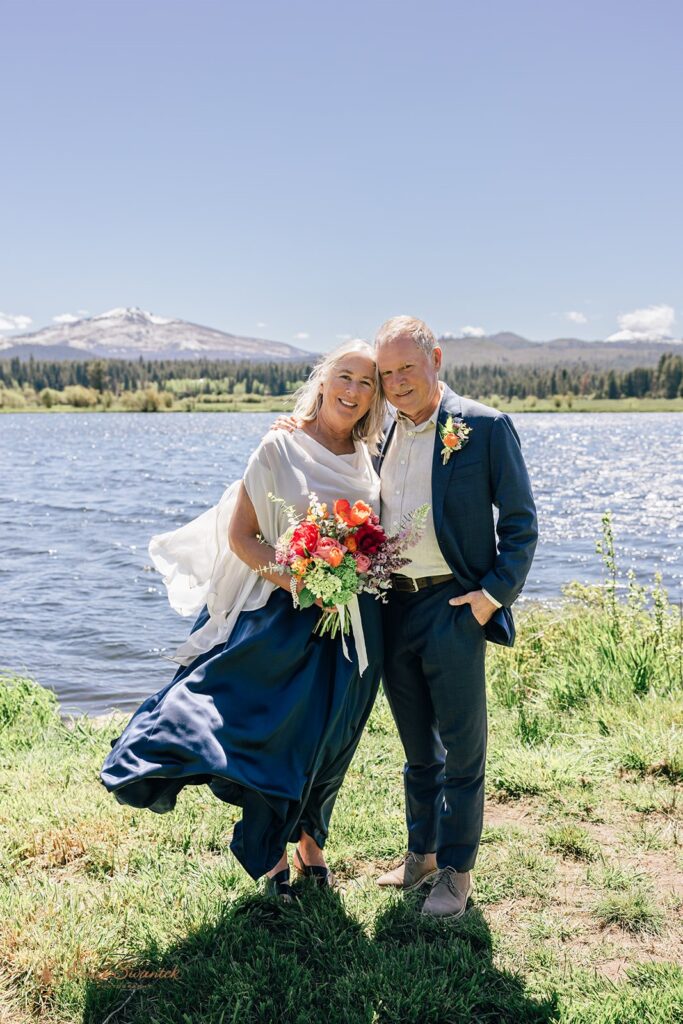 an elegant elopement couple with their dog with lake and mountain views in the backdrop in Oregon