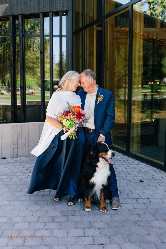 an elegant elopement couple with their dog with Black Butte Ranch in the backdrop